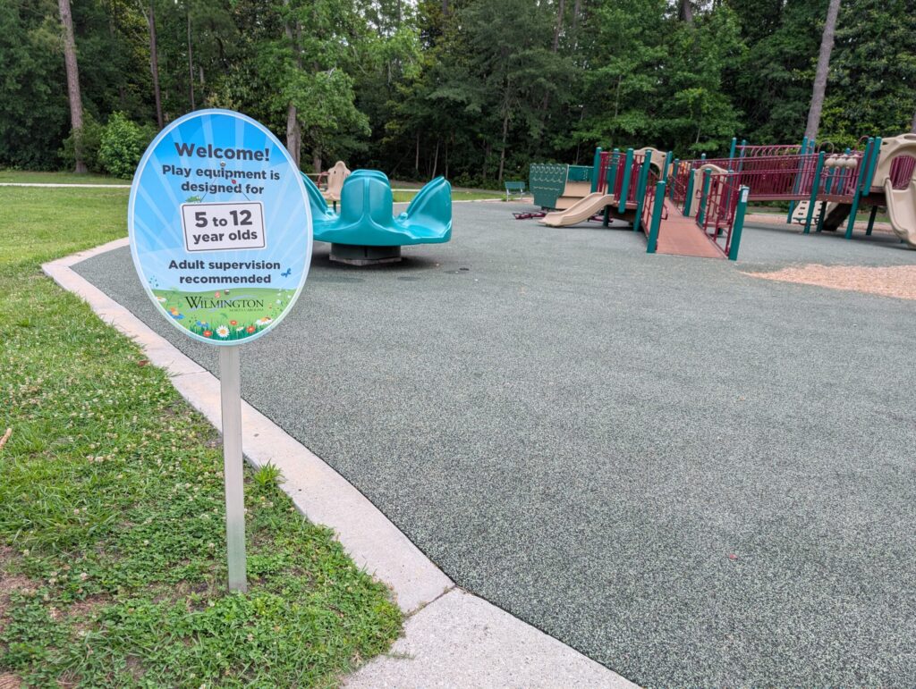 Sign noting playground is designed for ages 5 - 12 years old